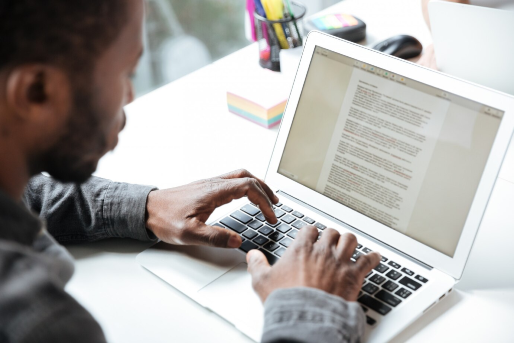 Person typing on laptop, blogging