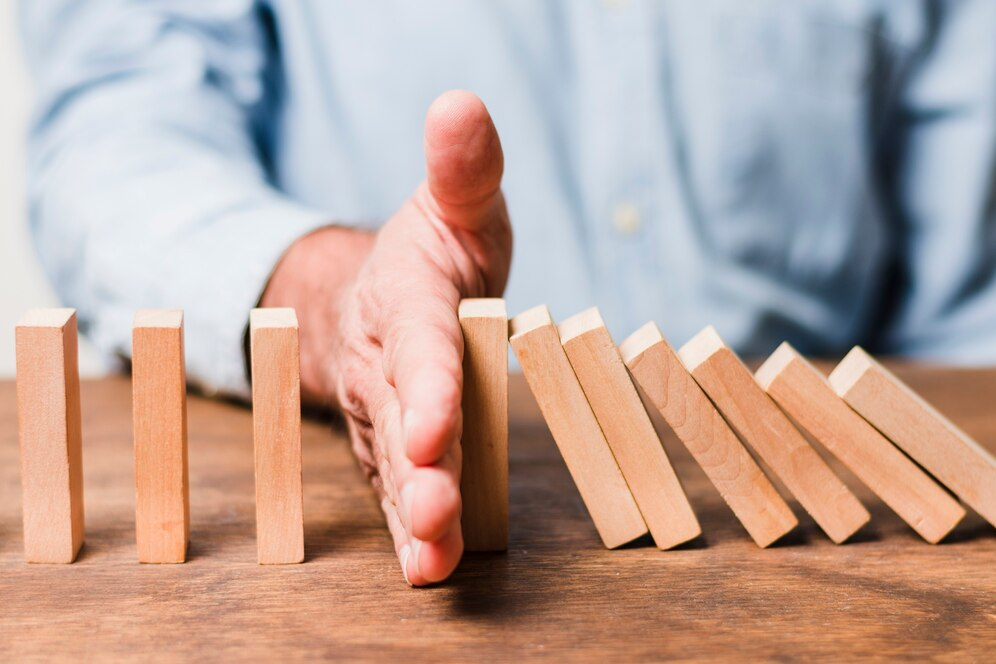 Businessman arranging wooden pieces