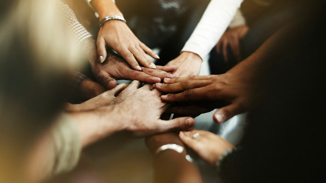 Diverse hands joining together