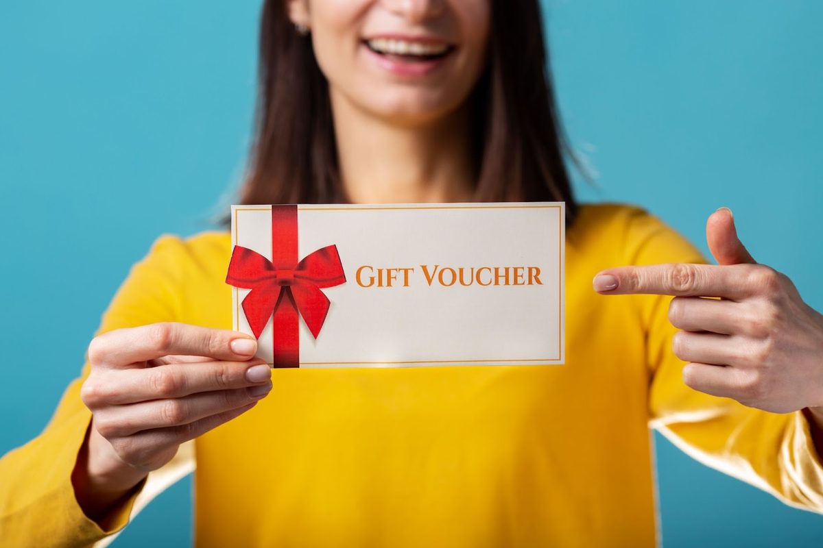 Hand holding a decorative gift voucher