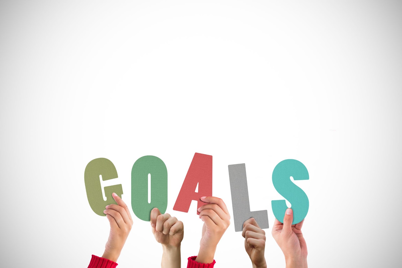 Team building the word 'Goals' together