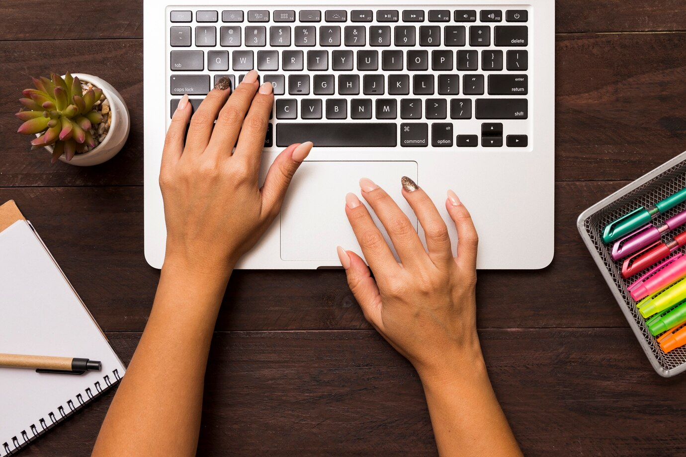 Female hands working on a laptop creating content