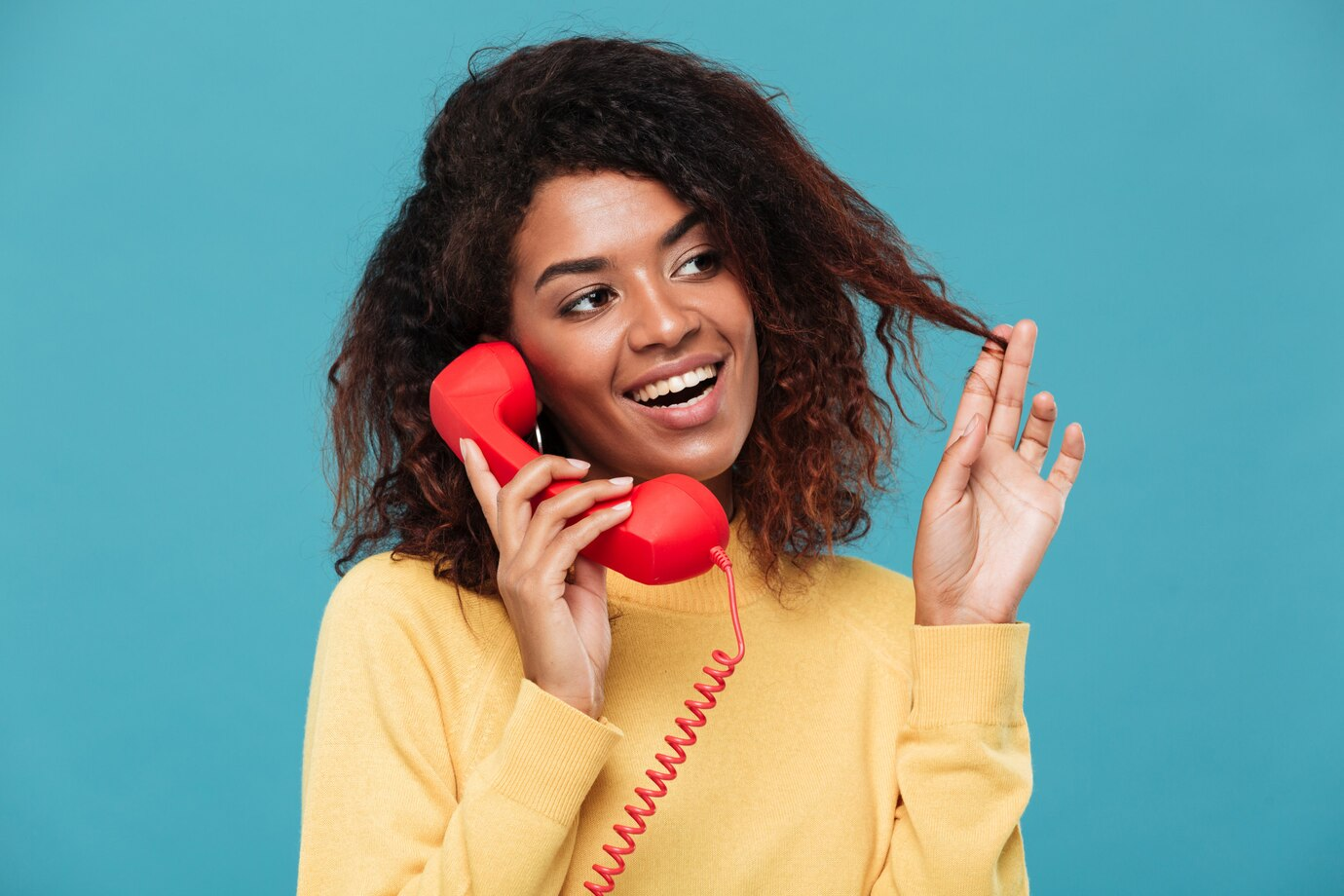 Cheerful young woman talking on the telephone