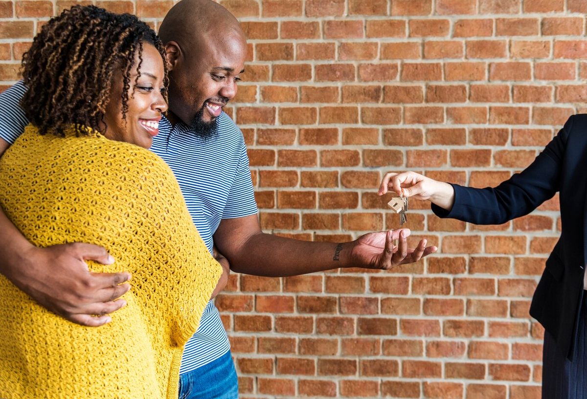 Couple buying a new house and receiving the keys