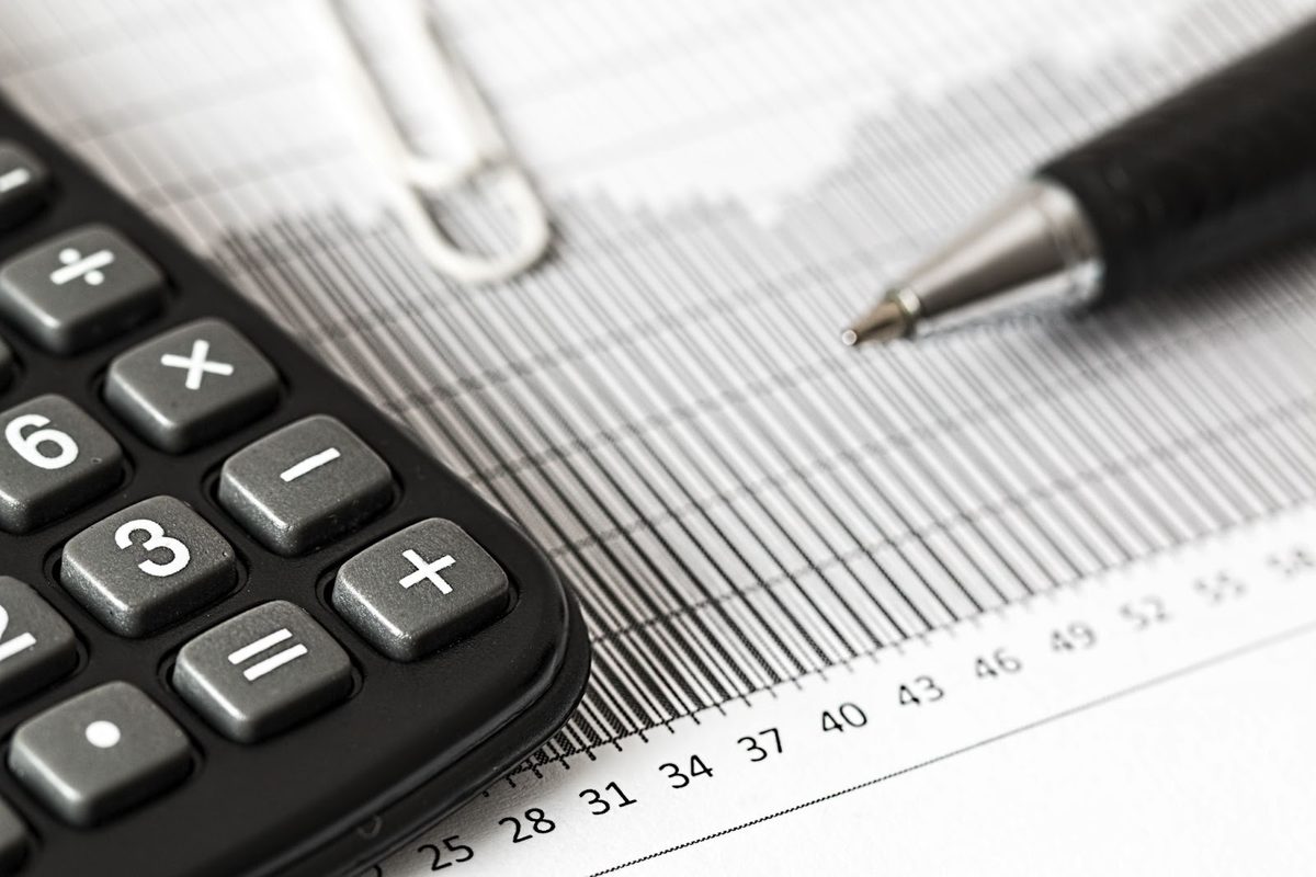 Calculator and paperwork used to work out real estate commission