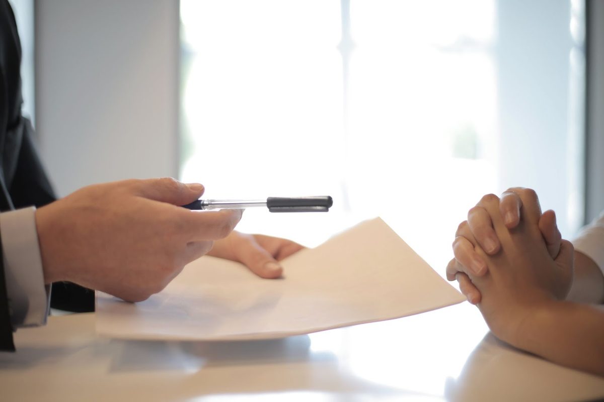 Compliance documents being reviewed at a desk