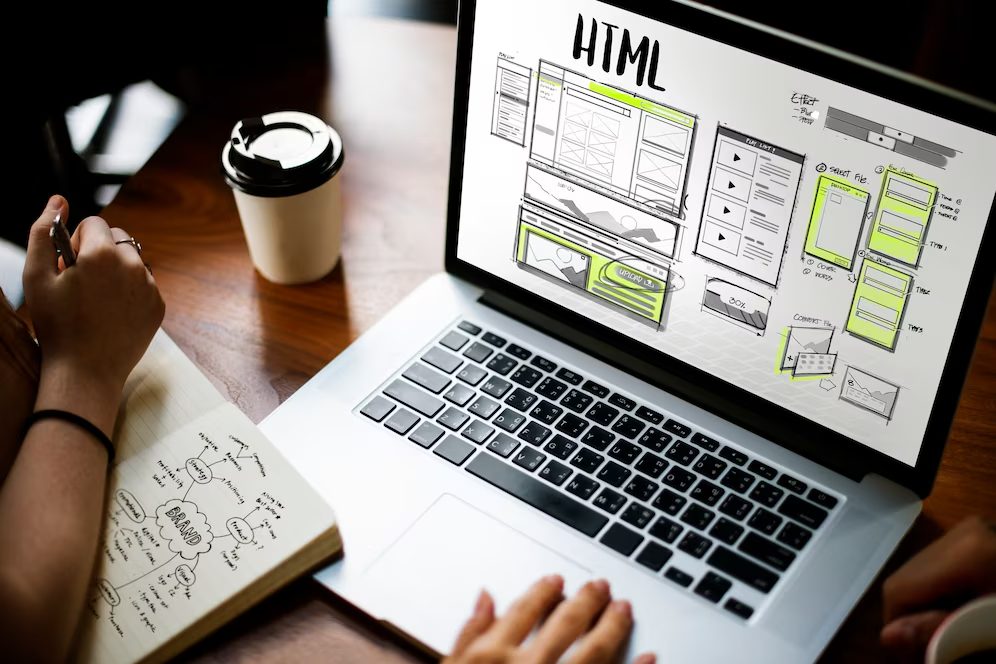 Person planning a website design on a laptop