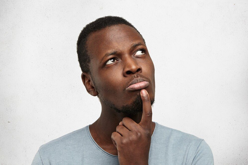 Person considering their options while looking upwards