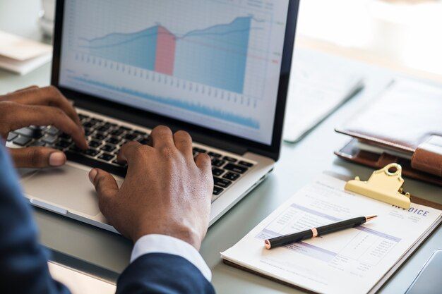 Businessman using a laptop to plan for growth