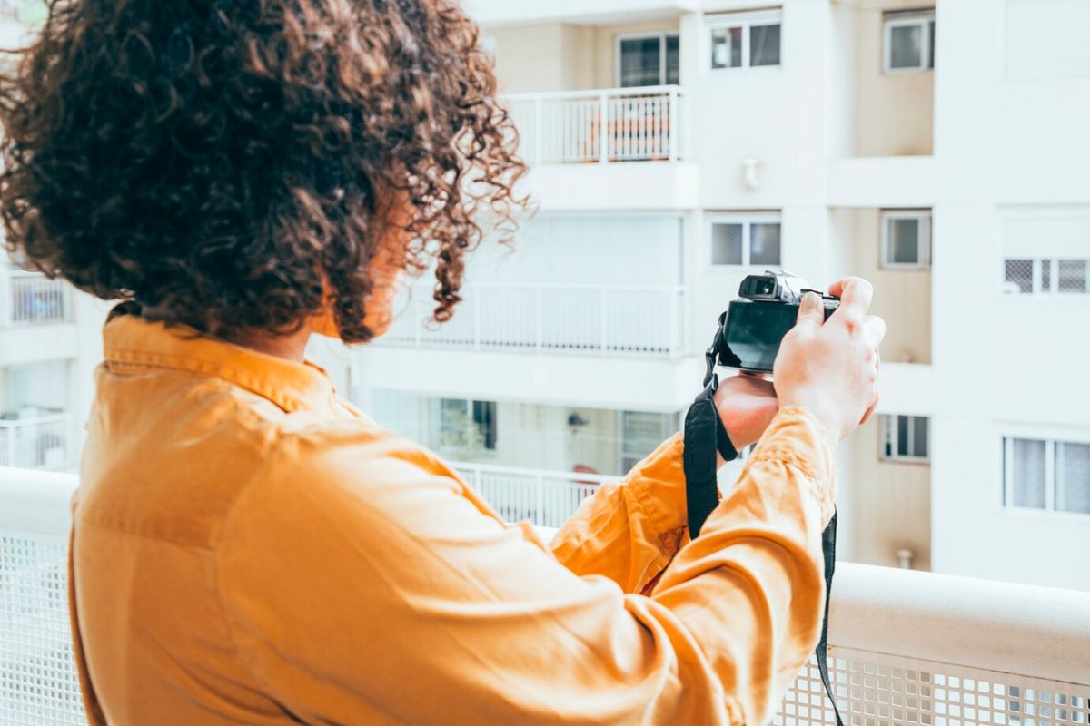 Agent filming a property walkthrough with a smartphone