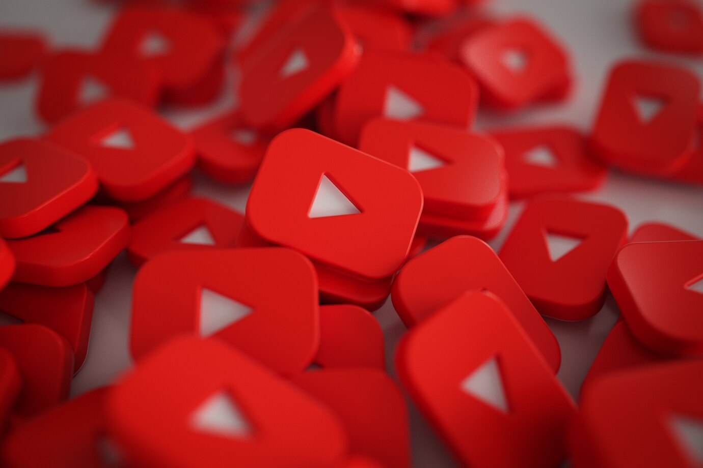 3D play button logos representing YouTube for real estate